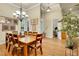 Bright dining room featuring hardwood floors, a chandelier, and large windows with shutters at 3198 Thatcher Ln, Tarpon Springs, FL 34688