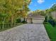 Beautiful single-story home boasting a three-car garage and a long brick paver driveway at 3198 Thatcher Ln, Tarpon Springs, FL 34688