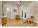 Living room with wood floors, white trim, a foosball table, and french doors at 3198 Thatcher Ln, Tarpon Springs, FL 34688