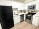 Well-organized kitchen featuring stainless steel appliances and white cabinetry at 320 Oak Rose Ln # 102, Tampa, FL 33612