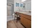 Bathroom with vanity, storage cabinet, decorative art, and a walk-in shower at 3212 Mcmath Dr, Palm Harbor, FL 34684