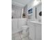 Bright bathroom with a tub and walk-in access, white vanity, and tile flooring at 3212 Mcmath Dr, Palm Harbor, FL 34684