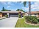 Well-kept home featuring a spacious driveway and an attached two-car garage at 3212 Mcmath Dr, Palm Harbor, FL 34684