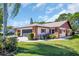 Charming single-story home with well-maintained landscaping and a screened two-car garage at 3212 Mcmath Dr, Palm Harbor, FL 34684