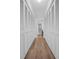 Hallway with closet space, modern flooring, and access to a bathroom at 3212 Mcmath Dr, Palm Harbor, FL 34684