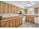 Well-maintained kitchen with wood cabinets, white appliances, and ample countertop space at 3212 Mcmath Dr, Palm Harbor, FL 34684