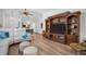Open-concept living space featuring wood floors, a white sofa, and decorative shelving at 3212 Mcmath Dr, Palm Harbor, FL 34684