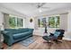 Bright living room featuring lots of natural light, wood-look floors, and comfortable seating at 3212 Mcmath Dr, Palm Harbor, FL 34684