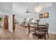 Bright, open-concept living room and dining area with wood floors and a stylish chandelier at 3212 Mcmath Dr, Palm Harbor, FL 34684