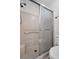 Clean, functional shower with tiled walls, a glass door, and basic fixtures at 3212 Mcmath Dr, Palm Harbor, FL 34684