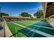 Well-maintained shuffleboard courts with covered seating and bright green playing surfaces at 3212 Mcmath Dr, Palm Harbor, FL 34684