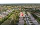 Aerial view showcases a charming neighborhood and a golf course with lakes at 3215 Banyan Hill Ln, Land O Lakes, FL 34639