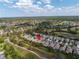 Aerial view showcasing a golf course community with lush greenery and scenic lakes at 3215 Banyan Hill Ln, Land O Lakes, FL 34639