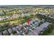 Aerial view showcases a charming neighborhood, a golf course, and nearby lakes at 3215 Banyan Hill Ln, Land O Lakes, FL 34639