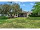 Private backyard with a screened patio creates the perfect space for relaxation and enjoyment at 3215 Banyan Hill Ln, Land O Lakes, FL 34639