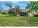 Enjoy a private outdoor living in a backyard featuring screened patio and lush lawn at 3215 Banyan Hill Ln, Land O Lakes, FL 34639