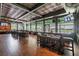 Interior space showcasing a bar with wood ceiling, hardwood floors, and floor to ceiling windows at 3215 Banyan Hill Ln, Land O Lakes, FL 34639