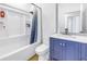 Bathroom featuring vanity and shower-tub combo with a blue shower curtain at 3215 Banyan Hill Ln, Land O Lakes, FL 34639