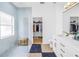 Bright bathroom featuring a marble shower, modern vanity, and walk-in closet at 3215 Banyan Hill Ln, Land O Lakes, FL 34639