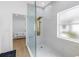Tiled walk-in shower with brass shower head, and bedroom access at 3215 Banyan Hill Ln, Land O Lakes, FL 34639