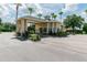 Exterior of gated entrance with mature landscaping, and stone elevation at 3215 Banyan Hill Ln, Land O Lakes, FL 34639
