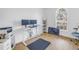 Bright home office featuring a standing desk, dual monitors, and a large arched window at 3215 Banyan Hill Ln, Land O Lakes, FL 34639