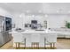 Bright kitchen with stainless appliances, white cabinetry, quartz counters, and decorative pendant lights at 3215 Banyan Hill Ln, Land O Lakes, FL 34639