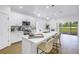 Bright kitchen showcasing quartz countertops, white cabinets and stainless steel appliances at 3215 Banyan Hill Ln, Land O Lakes, FL 34639