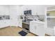 Bright kitchen showcasing the stainless steel stove, white cabinets and quartz countertops at 3215 Banyan Hill Ln, Land O Lakes, FL 34639