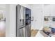 Stainless steel LG refrigerator in the bright kitchen with white cabinets and stainless steel appliances at 3215 Banyan Hill Ln, Land O Lakes, FL 34639