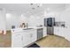 Gourmet kitchen with white cabinets, stainless appliances, quartz counters and pendant lighting at 3215 Banyan Hill Ln, Land O Lakes, FL 34639