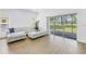 Bright living room with a white sofa, ottoman, and a sliding glass door at 3215 Banyan Hill Ln, Land O Lakes, FL 34639
