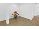 Minimalist living space with wood-look floors and a whimsical minion figurine at 3215 Banyan Hill Ln, Land O Lakes, FL 34639
