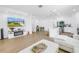 Open concept with modern kitchen and living area, featuring white accents and decor at 3215 Banyan Hill Ln, Land O Lakes, FL 34639