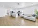 Open living space featuring a modern kitchen and cozy living area with white furniture at 3215 Banyan Hill Ln, Land O Lakes, FL 34639