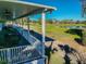 Exterior view of open patio space with tables, chairs and views of the lush golf course at 3215 Banyan Hill Ln, Land O Lakes, FL 34639