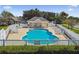Beautiful view of a community pool with plenty of seating, privacy fence, and bathrooms at 3215 Banyan Hill Ln, Land O Lakes, FL 34639