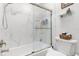 Bright bathroom featuring marble tiling and a modern glass shower enclosure at 35128 Excalibur Rd, Webster, FL 33597
