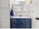 Bathroom vanity featuring modern vanity with navy cabinets and white countertop at 35128 Excalibur Rd, Webster, FL 33597