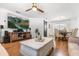 Spacious living room with an entertainment area, barn door accent, and a dining space with modern lighting at 35128 Excalibur Rd, Webster, FL 33597