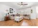 Cozy living room with a comfortable sectional sofa, wood-look flooring, and a ceiling fan for added comfort at 35128 Excalibur Rd, Webster, FL 33597