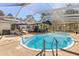 Enjoy the beautiful inground pool featuring a screened enclosure and lounge chairs at 35128 Excalibur Rd, Webster, FL 33597