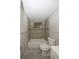 Neutral tiled bathroom features a tub with shower and stylish fixtures at 3603 Darlington Rd, Holiday, FL 34691