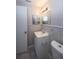 This is a tiled bathroom with decorative beadboard, a vanity with sink, and a large mirror at 3603 Darlington Rd, Holiday, FL 34691