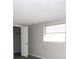 Bright bedroom featuring a large window with a closet for storage at 3603 Darlington Rd, Holiday, FL 34691