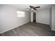 Bedroom features new floors, ceiling fan, closet, and a large window at 3603 Darlington Rd, Holiday, FL 34691