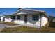 Three-quarter view of the home with an attached garage, neutral color palette, and covered front porch at 3603 Darlington Rd, Holiday, FL 34691