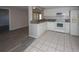 Bright kitchen features white appliances, white cabinets, and granite countertops at 3603 Darlington Rd, Holiday, FL 34691