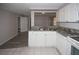 The kitchen features white cabinets, granite countertops, and stainless steel sink at 3603 Darlington Rd, Holiday, FL 34691