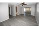 Open floor plan living room features new floors and access to the bathroom at 3603 Darlington Rd, Holiday, FL 34691